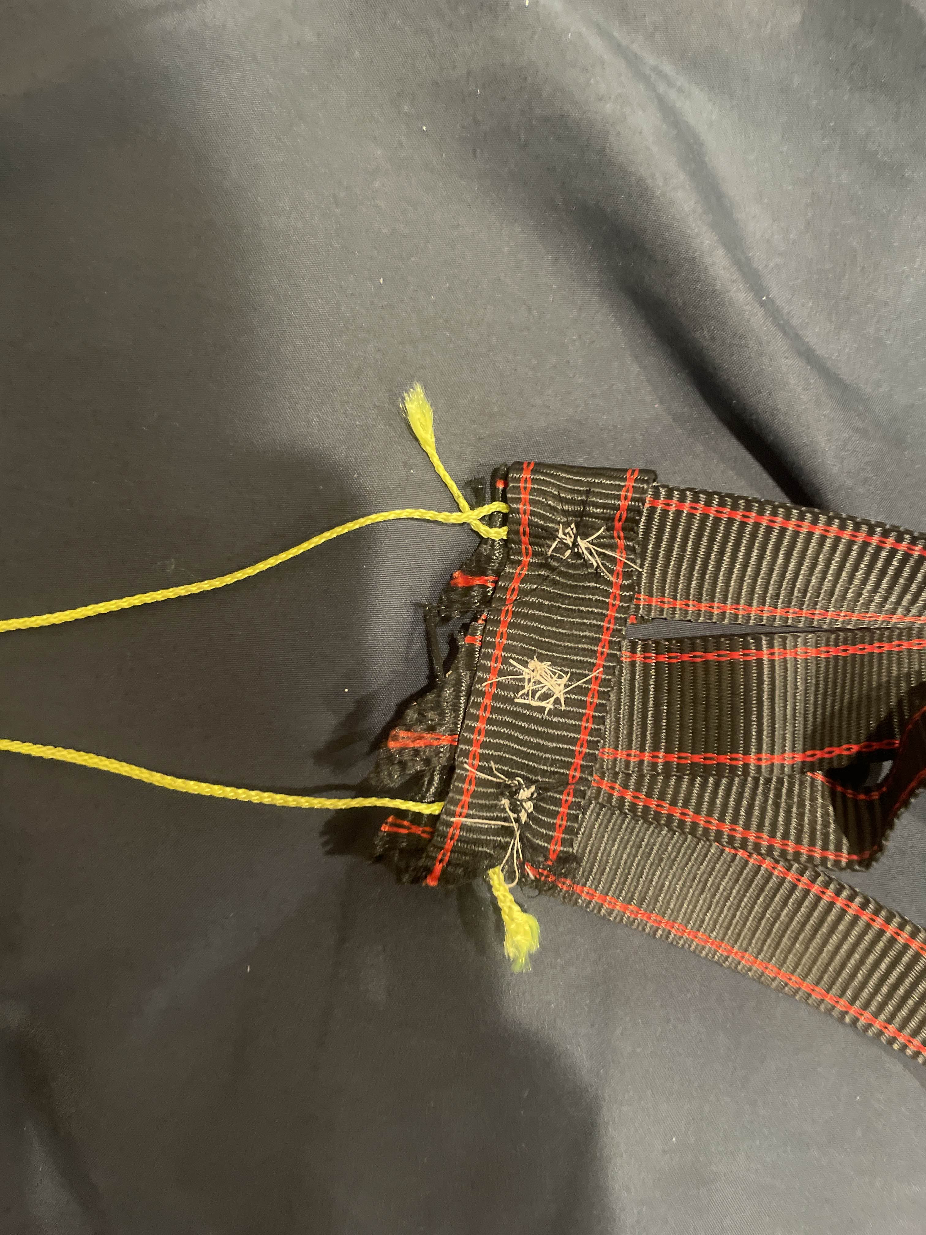 Cloth-and-string sling used to hold the mini pumpkin